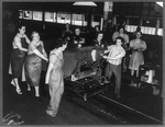 A Jeep body being hauled into position on the Willys-Overland hardware assembly line ...