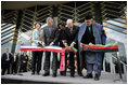 President George W. Bush and Afghanistan President Hamid Karzai, right, cut the ceremonial ribbon, Wednesday, March 1, 2006, to dedicate the new U.S. Embassy Building in Kabul, Afghanistan. President Bush is joined by Mrs. Laura Bush; U.S. Secretary of State Condoleezza Rice and U.S. Ambassador to Afghanistan Ronald E. Neumann.