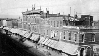 Storefront awnings over sidewalks and entrances were typical features of American streetscapes for much of the 19th and 20th centuries. Photo of Larimer Street, Denver, Colorado, c. 1870, Denver Public Library, Western History Collection, x-22058.