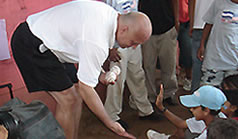 Photo of Cal Ripken, Jr. greeting kids from Barrio La Esperanza where he donated Quickball sets and school supplies and the Cal Ripken, Sr. Foundation made a contribution to Empowerment International that will send 20 kids to school for a year.