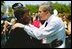 President George W. Bush talks with a woman attending the Annual Peace Officers' Memorial Service at the U.S. Capitol in Washington, D.C., Saturday, May 15, 2004. 