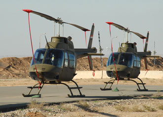 Two Bell Jet Ranger 206B helicopters sit ready after passing a government acceptance inspection at Kirkuk Regional Air Base, Iraq, Dec. 4, 2008.  Photo by Master Sgt. Andrew Leonhard, 506th Air Expeditionary Group Public Affairs.