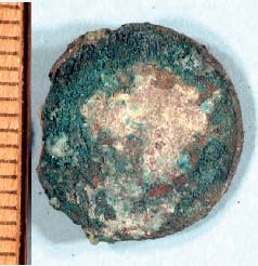 a. Corroded subway token as recovered