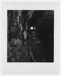 Unidentified woman coal miner, half-length portrait, facing front, with helmet in coal mine in Appalachia
