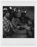 Three women coal miners, seated in a mine in West Virginia