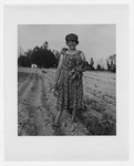 Unidentified female tobacco worker, full-length portrait, facing front, standing in a field after the tobacco harvest