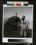 Black fighter pilot series--pilot with parachute room in background, Ramitelli, Italy