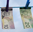 dollar bills hanging on clothesline