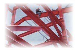 picture of man atop steel rafters