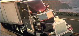 Photo of an 18 wheeler truck with ocean in background.