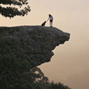 Photo of a man and dog on a mountain