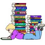 A picture of a child laying down reading a book with two tall stacks of books behind him