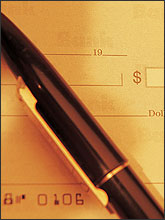 Photo of a pen and checkbook.