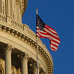Photo of an American flag flying over the Capitol Building