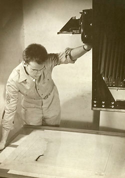 Image of John Enman examining aerial photographs