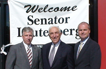 Senator Lautenberg receives a warm welcome at the Verizon control center in Freehold. Verizon's FiOS system, which offers telephone, Internet and now television service, is housed in the Freehold center. Greeting the Senator were Dennis Bone, President of Verizon New Jersey (left), and Bill Foshay, Senior Vice President and General Manager of Verizon's New Jersey region. (September 5, 2008)