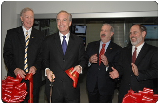 Secretary Dirk Kempthorne, center, cuts the ceremonial ribbon officially opening the Interior Operations Center, a state-of-the-art communications facility that will improve the Department's ability to respond to emergencies and natural disasters.  At right is Larry Parkinson, Deputy Assistant Secretary for Law Enforcement and Security; second from right is Larry Broun, Director of the Office of Emergency Management; at far left is Chuck Franklin, Office of Emergency Management. [Photo by Tami Heilemann, NBC]