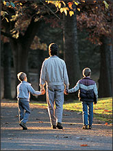 Photo of a family walking down as residential street.