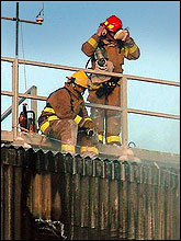 Photo of two fireman.