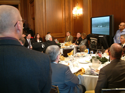 Gathered in the U.S. Capitol’s Mike Mansfield Room, Members of Congress, military officials, and survivors of the attack on Pearl Harbor watch a live broadcast of memorial ceremonies at Pearl Harbor.