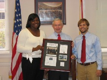 Dana Todd of Hale County and Robert Martin of Houston County present a plaque to Sen. Sessions in Birmingham recognizing his work with the Rural Medical Scholars, a group of leaders from the University of Alabama committed to developing healthy communities in rural Alabama. (10/27/06)
