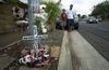 Family members built a roadside memorial for Michael Galutira in Waipahu; he was one of three traffic fatalities on New Year's Day.
