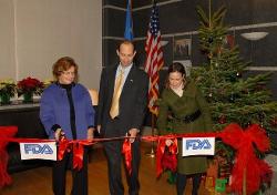 December 4, 2008 - The Honorable Tevi D. Troy, Ph.D., Deputy Secretary of the U.S. Department of Health and Human Services (HHS), cuts the ribbon to open the European office of the HHS Food and Drug Administration (FDA), at the U.S. Mission to the European Union (EU), in Brussels, Belgium. To the left of the Deputy Secretary is RADM Linda Tollefson, who will head up the HHS/FDA European team; to the right of the Deputy Secretary is the Honorable Kristen Silverberg, U.S. Ambassador to the EU.