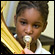 A young student at Baltimore's Harriet Tubman Elementary School plays a horn. Credit: Kirsten Beckerman