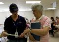 Wapello, Iowa, June 28, 2008 -- Donna Althof, Manager of the FEMA/State  Disaster Recovery Center, explains to Benita Grooms, the Mayor of Oakvill...