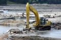 Lake Delton, WI, June 23, 2008 -- Track loader is moving debris in a lake bed in Wisconsin to repair and rebuild a dam. Lake Delton was emptied wh...
