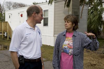 Galveston, TX, December 9, 2008 -- Deputy FEMA Director Harvey Johnson chats with Linda Sue Martin in front of the new FEMA mobile home she now li...