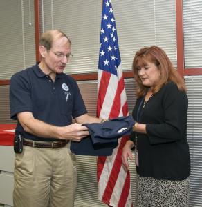 Galveston, TX, November 13, 2008 -- FEMA Deputy Director, Admiral Harvey Johnson gives a FEMA shirt to Celeste DeLisle, after she was sworn in as ...