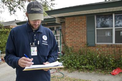 Bridge City, TX, November 5,2008 -- Ben Juday, a member of the FEMA housing strike force, checks the address of a home in Bridge City, TX.  FEMA h...