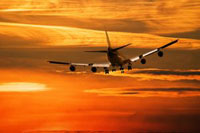 Airplane in sky against the sunset. Photo Credit: Marja Flick-Buijs