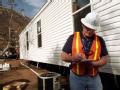 Delzura, CA, December 6, 2007 -- Mark Ares, of CH2M Hill, Inc., inspects a FEMA-provided mobile home as part of the Ready for Occupancy inspection...
