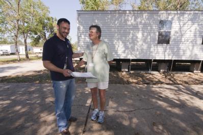 Bridge City, Texas, October 21,2008 -- A FEMA housing expert talks to a resident in Bridge City, TX about her new mobile home. FEMA is working wit...
