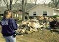 Norfork, AR, March 26, 2008  -- Beverly Palmer, a Federal Emergency Management Agency Individual Assistance specialist, looks over the remnants th...