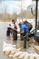 Biscoe, AR, March 26, 2008 -- Locals volunteer in an effort to save houses near the Cache River, a tributary of the White River, which has been fl...
