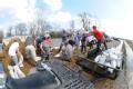 Biscoe, AR, March 26, 2008 -- Locals volunteer in an effort to save houses near the Cache River, a tributary of the White River, which has been ex...