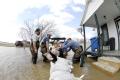 Biscoe, AR, March 26, 2008 -- Locals volunteer in an effort to save houses near the Cache River, a tributary of the White River, which has been ex...