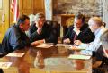 Little Rock, AR, March 31, 2008 -- FEMA Administrator Dave Paulison, left, speaks  with Arkansas Governor Mike Beebe, center and Senator Mark Pryo...