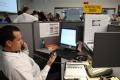Baton Rouge, LA, September 3, 2008 -- Infrastructure Branch/ Communications employee in the EOC, sits at desk with two phones, during disaster rec...
