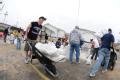 Fenton, MO, March 21, 2008 -- Local residents and area volunteers move sandbags by wheel barrow to stack them next to businesses and property on t...