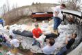 Fenton, MO, March 22, 2008 -- Local residents and area volunteers band together to fill sand bags and stack them next to businesses and property o...