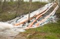 Brookport, IL, April 12, 2008 -- Flood water is pumped over the levee to reduce pressure on the bank.  FEMA/Marty Bahamonde