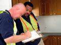 March Air Force Base, CA, November 20, 2007 -- Edward Coulter, left, a FEMA worker, and Anthony Johnson, a FEMA Individual Assistance liaison, dis...