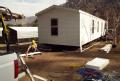 Delzura, CA, December 6, 2007 --  A contractor from Greg Wanket Construction installs the skirting of a FEMA provided mobile home to prepare it fo...