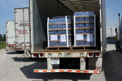 Rock Island, IL, June 19, 2008 -- Pallets of bottled water are loaded in trailer trucks at the Rock Island Army Arsenal and ready for delivery as ...
