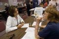 Waterloo, IA, June 20,2008 -- Undersecretary For Agriculture, Nancy Montanez-Johner talks with Gretel Keene, a FEMA representative at the Disaster...