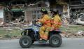 Parkersburg, IA, May28,2008 -- Parkersburg firemen survey the damaged homes from an EF-5 tornado while riding on an ATV.  Barry Bahler/FEMA